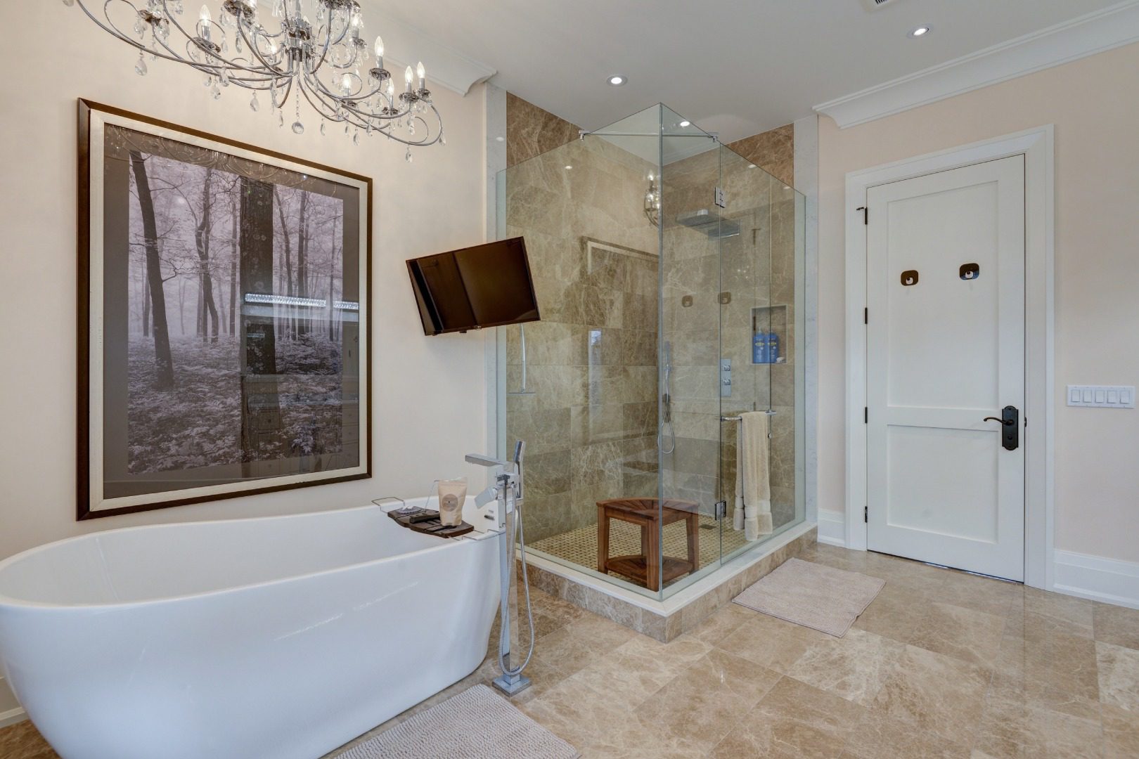A white tub with a separate shower space with mirror